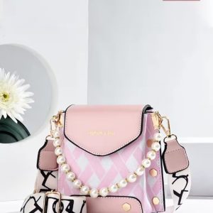 Blush pink crossbody handbag with check-pattern texture, pearl chain detail, flap closure, and printed adjustable shoulder strap.