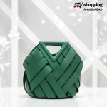 Emerald green woven handbag with geometric basket-style pattern and structured triangle top handle.